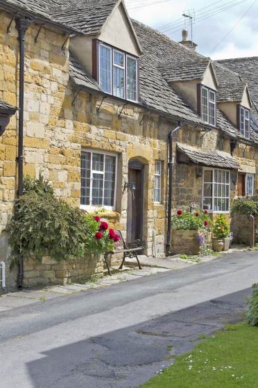 Street view on stone cottages in an English village