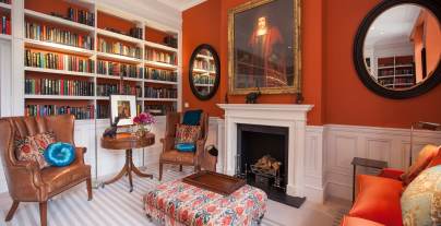 Luxury lounge with bookshelves and large fireplace