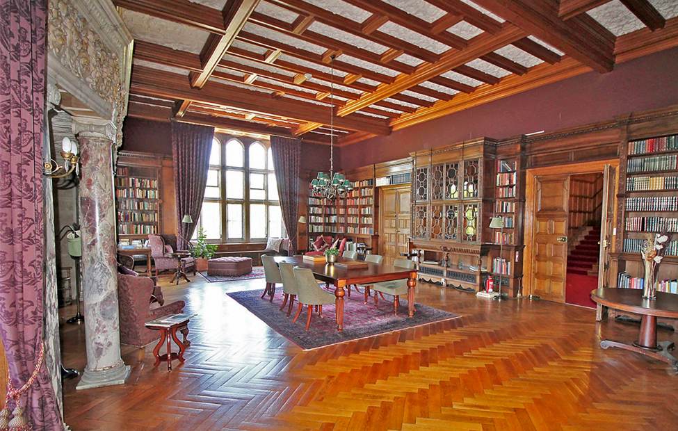 Wood-panelled library with parquet floor